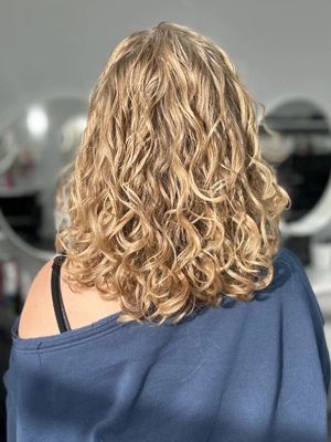 Golden blonde curls with volume and body by Alexis