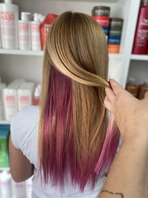 Blonde hair with bright pink peekaboo panels by Chloe