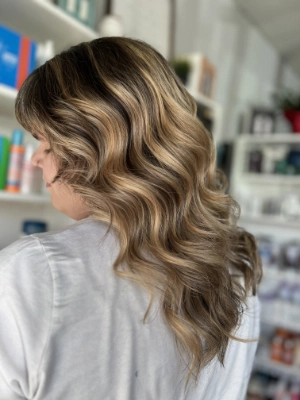Golden blonde balayage with loose curls by Madi