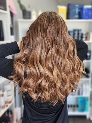 Long honey brown with blonde highlights and loose waves by Sherri